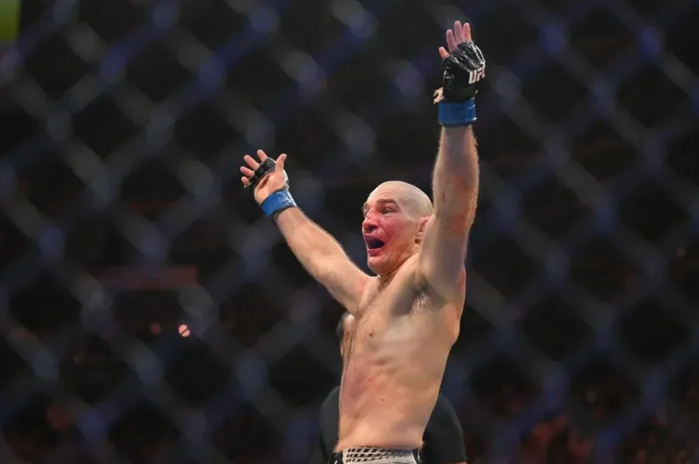 May 9, 2026; Newark, New Jersey, UNITED STATES; Sean Strickland (blue gloves) celebrates after defeating Khamzat Chimaev (red gloves) during UFC 328 at Prudential Center. Mandatory Credit: John Jones-Imagn Images